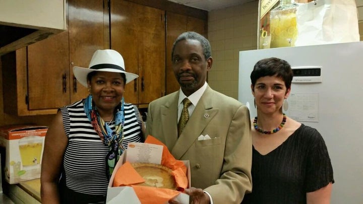 The Rev. Norvell Goff receiving a sweet potato pie from Rose McGee (left) and Eden Bart. Photo courtesy of Kate Towle.