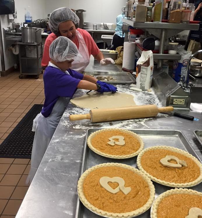Volunteers work to prepare 86 pies for Rose McGee's Charleston church pie gift.