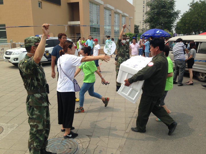 Volunteers bring supplies into a school that is being used as a shelter for those affected by the explosion.