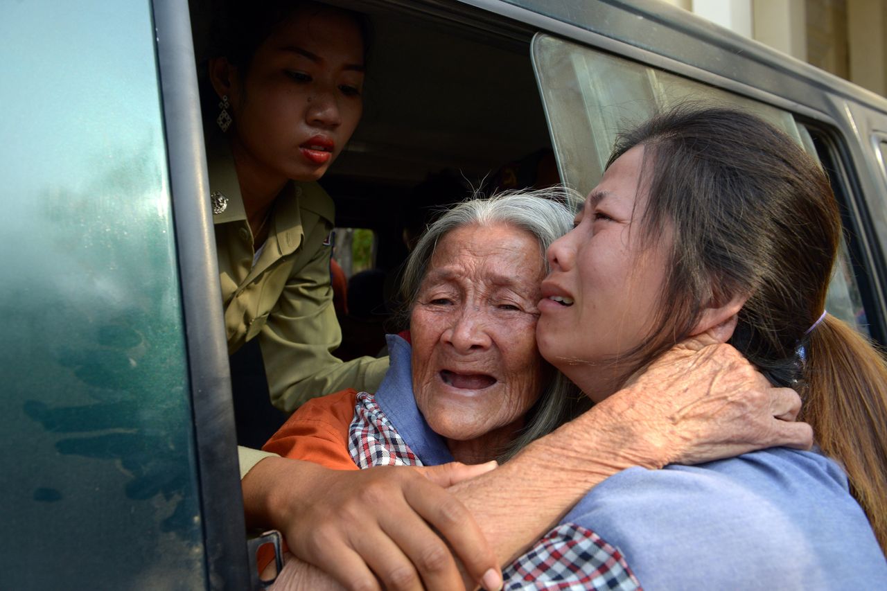 Cambodian land rights activist Nget Khun hugs her daughter through a window of a prison car before a court hearing in Phenom Penh on Jan. 26, 2015. Khun was arrested for protesting against evictions connected to a World Bank-financed land management program.
