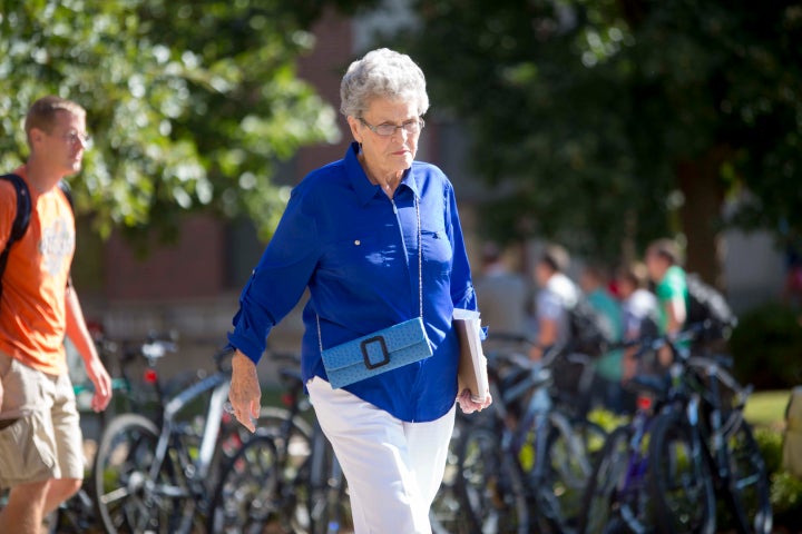 <p>Jean Kops walks across the UNL campus after her morning classes in 2013. </p>