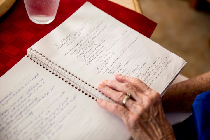 <p>Jean Kops reviews some of her notes from class at her kitchen table.</p>