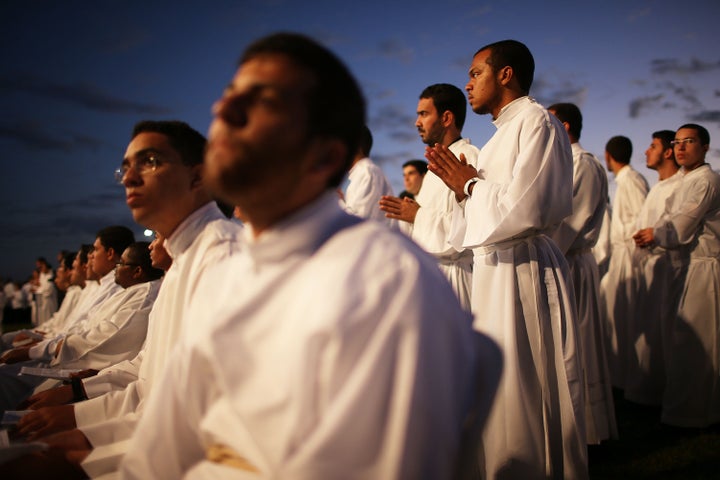 Catholic priests gather outside of the Cathedral of Brasilia while celebrating the holiday of Corpus Christi on June 4, 2015 in Brasilia, Brazil.