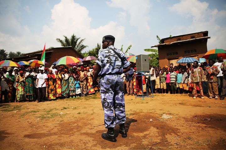 A member of an elite police force stands guard as a member of the ruling party speaks on June 23, 2015 in Mpanda, Burundi.