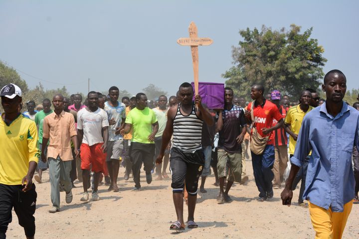 People attend a funeral service for opposition activist Emmanuel Ndayishimiye, who was shot dead by gunmen in Bujumbura, Burundi on July 23, 2015. 