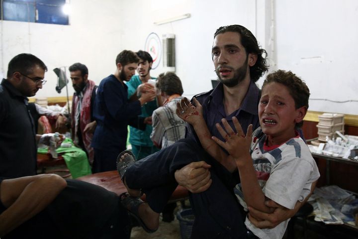  Syrian injured boy arrives to receive treatment at a make-shift hospital in the rebel-held area of Douma, east of the capital Damascus, following air strikes by Syrian government forces on a marketplace on August 16, 2015.
