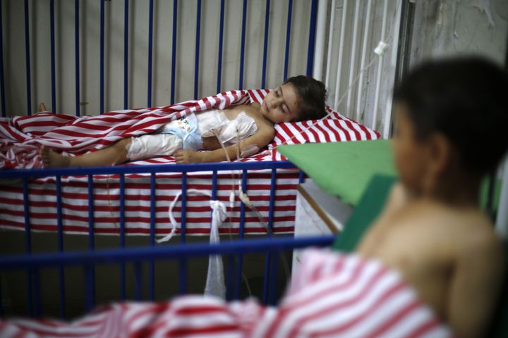 Maya, a 4-year-old Syrian girl, lies in a hospital bed after she was injured the day before following air strikes by Syrian government forces on a marketplace in the rebel-held area of Douma, east of the capital Damascus on August 17, 2015.