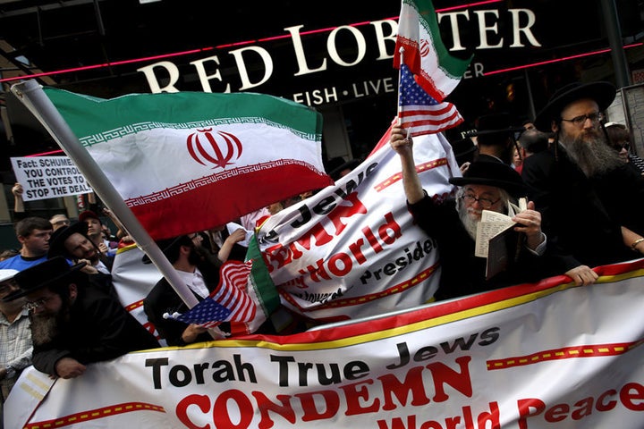 A group of Orthodox Jewish counterdemonstrators wave American and Iranian flags as they stand amid protesters who were demonstrating against the nuclear deal with Iran during a rally in Times Square in the Manhattan borough of New York City on July 22, 2015. 