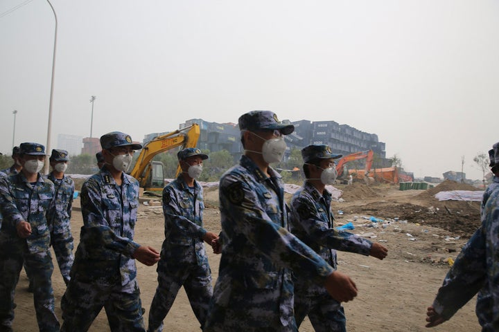 Representatives of People's Liberation Army and public security attend the mourning for the dead in Tianjin warehouse explosi