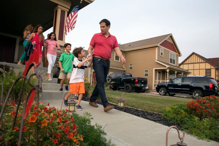 Republican presidential candidate Sen. Marco Rubio (R-Fla.) holds hands with his son, Anthony, as he leaves the porch of Steve and Donna Shelley while campaigning in Ankeny, Iowa, Monday, Aug. 17, 2015. Behind Rubio and his son is from right, son Dominick, daughters Daniella and Amanda, and wife Jeanette Dousdebes Rubio. (Photo By Al Drago/CQ Roll Call)