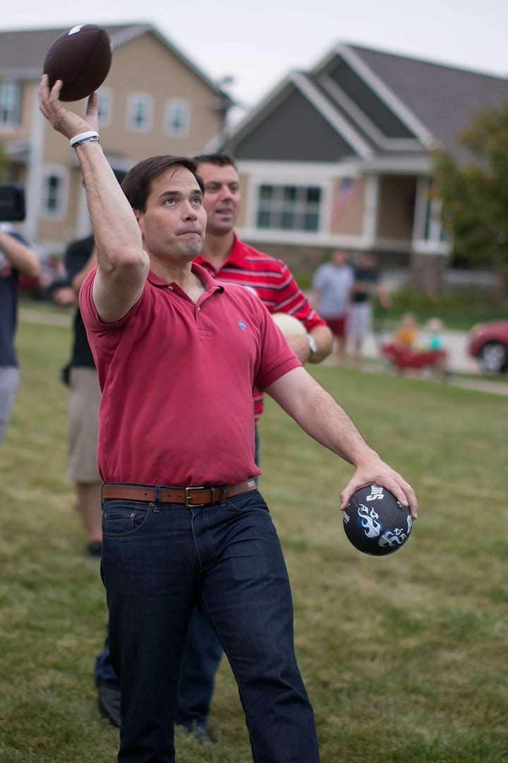 Republican presidential candidate Sen. Marco Rubio (R-Fla.) throws a football with children during a Family Ni