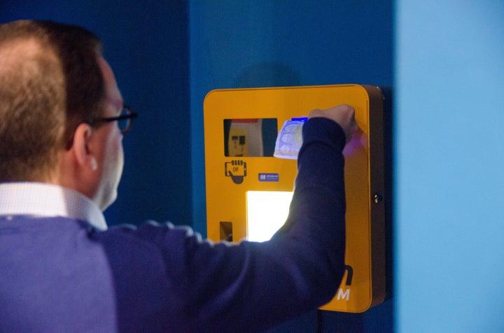 A man sends and receives payments with a Bitcoin machine in Gent, Belgium, on March 29, 2015.