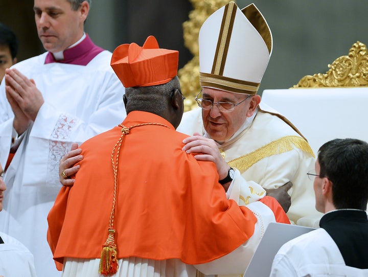 Pope Francis embraces Cardinal Philippe Ouedraogo of Burkina Faso.