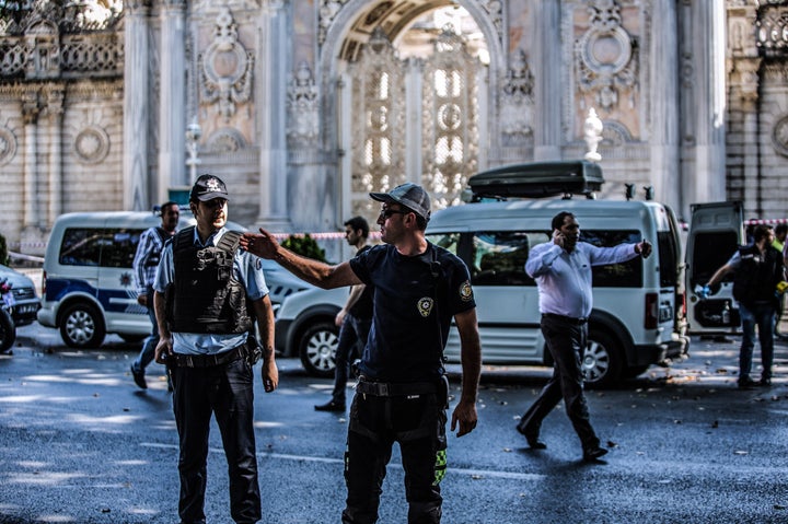 Turkish police officers work at the site where shots were fired at police officers on Aug. 19, 2015 at Dolmabahce palace in Istanbul.