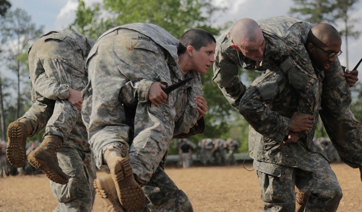 Capt. Kristen Griest (center) carrying a classmate during ranger school. 