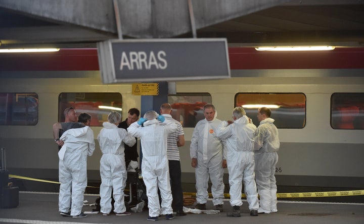 Criminal and forensic investigators stand on a platform at a train station in Arras, France, on Aug. 21, 2015.