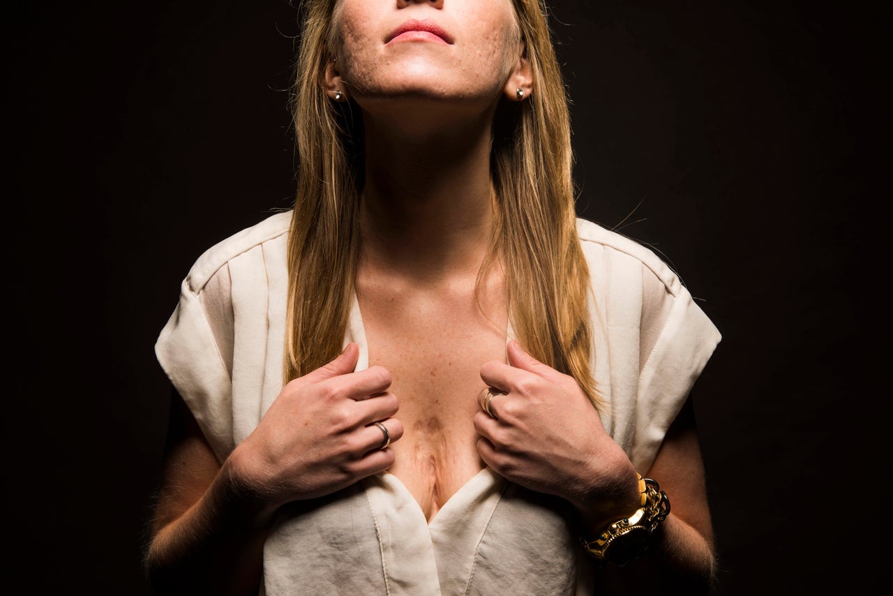 Portrait of Young Woman Pointing Fingers at Her Breast Chest with