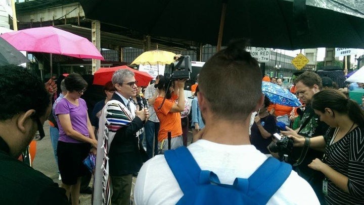 Rabbi Brant Rosen, center left, speaks during a Moral Monday’s demonstration in Chicago, Ill. in August 2015. 