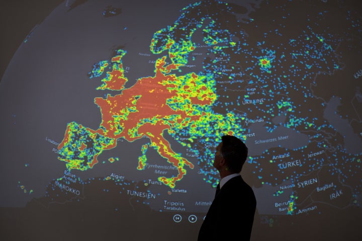A man stands in front of a picture displaying activities of a so-called "botnet" in Frankfurt am Main, Germany, on July 31, 2