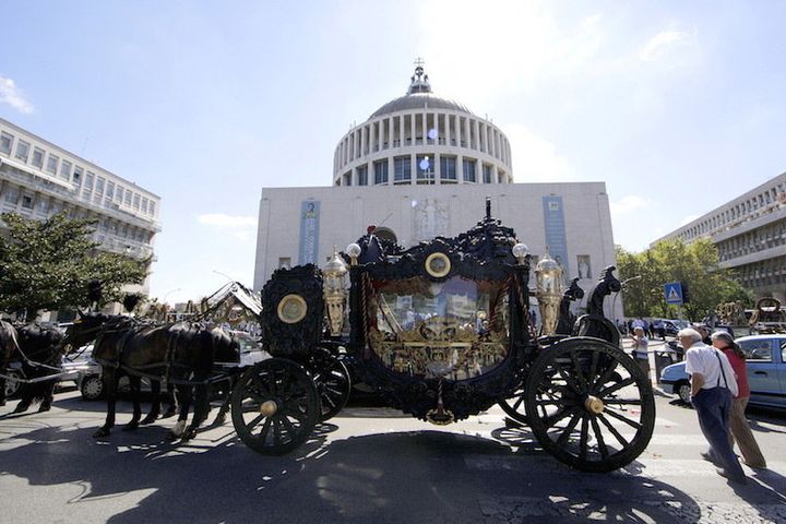 An ornate hearse pulled by six, black-plumed horses, carries the body of Vittorio Casamonica by a Roman Catholic basilica in the Rome suburbs, where a funeral Mass was celebrated August 20, 2015.  