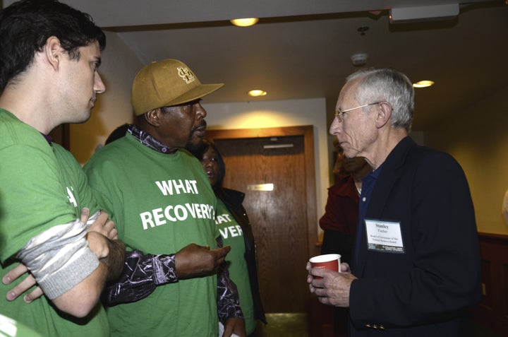 Stanley Fischer, Vice Chairman of the Federal Reserve Board of Governors, talks with Fed Up campaign activists at the 2014 Jackson Hole symposium.