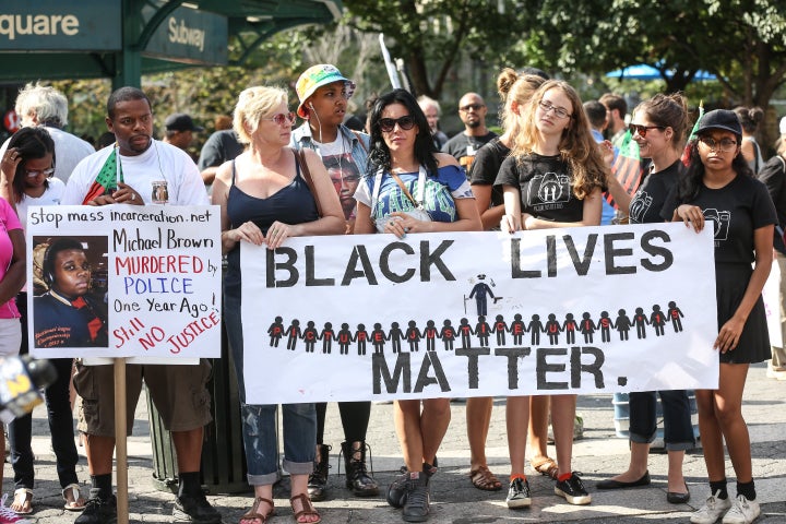 Protesters march behind a banner of "Black Lives Matter" on August 9 in New York, one year after the death of unarmed black teenager Michael Brown in Ferguson, Missouri. The Fed Up campaign is invoking many of the same themes of racial inequality in the actions it is planning for the Kansas City Fed's Jackson Hole symposium later this week. 