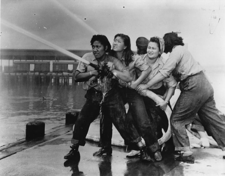 Katherine Lowe is the second woman from the right. From Getty: "Women fire fighters during a training exercise at the Pearl Harbor Naval Shipyard, during World War II."