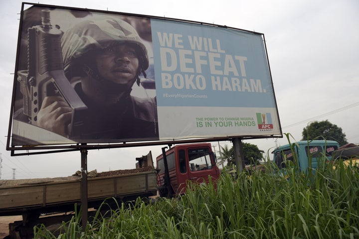 A photo shows a campaign signboad displayed by the ruling All Progressives Congress (APC) to show its readiness to defeat Boko Haram Islamists on assumption office at Ogijo, Ogun State in southwest Nigeria, on July 3, 2015. 