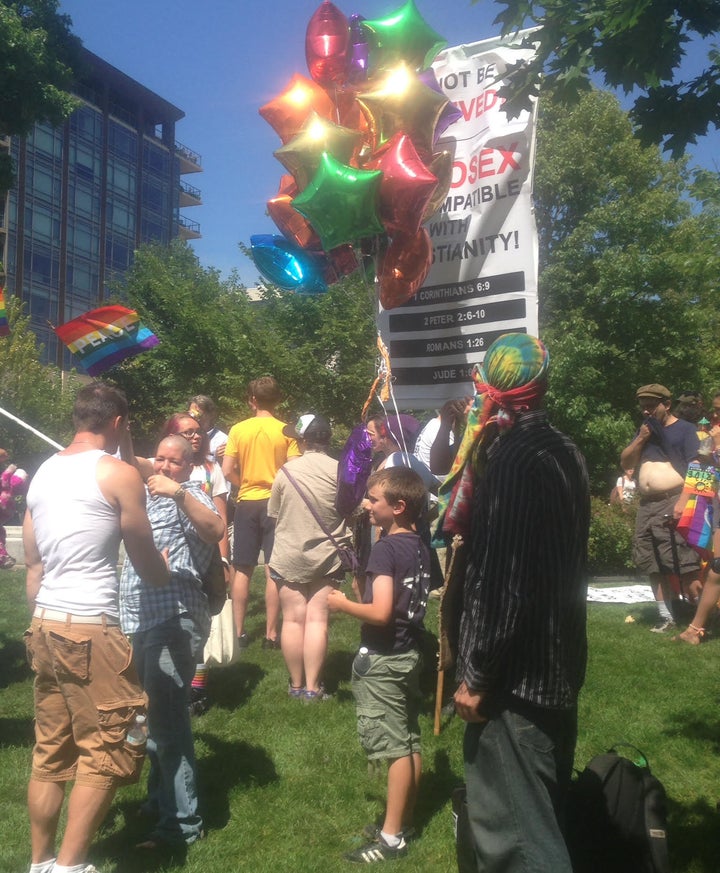 Keanan Sargent, 9, holds up a bunch of balloons in front of an anti-gay protester during a pride rally in Madison, Wisconsin.