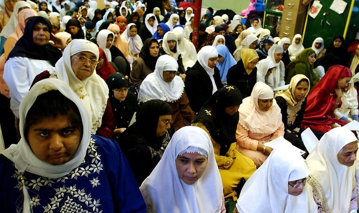 Girls adjust their headscarves before an Islamic prayer service for News  Photo - Getty Images