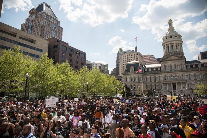 People attend a rally lead by faith leaders in front of city hall calling for justice in response to the death of Freddie Gray on May 3, 2015 in Baltimore, Maryland. Gray later died in custody; the Maryland state attorney announced on Friday that charges would be brought against the six police officers who arrested Gray. (Photo by Andrew Burton/Getty Images)