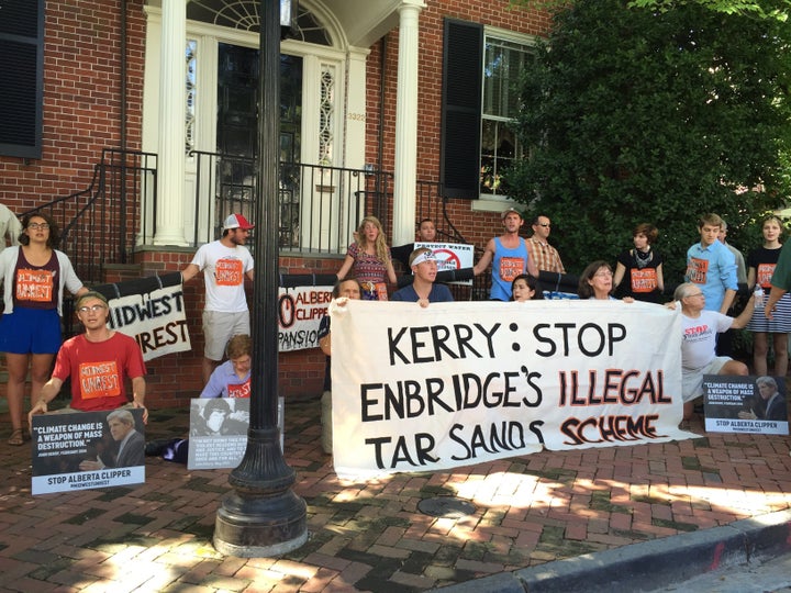 Environmental activists protest outside Secretary of State John Kerry's home.