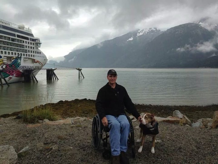 <p>Matthew Smith and Jericho, his service dog, pose for a picture outside of their Alaskan cruise ship.</p>