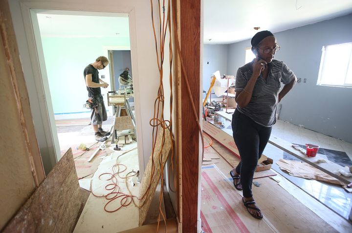 Esther Joseph (R) stands in her home which is being rebuilt with the help of volunteers from lowernine.org in the Lower 9th Ward on August 24, 2015, in New Orleans, Louisiana. The area was one of the most heavily devastated areas of the city following a levee breach during the aftermath of Hurricane Katrina.