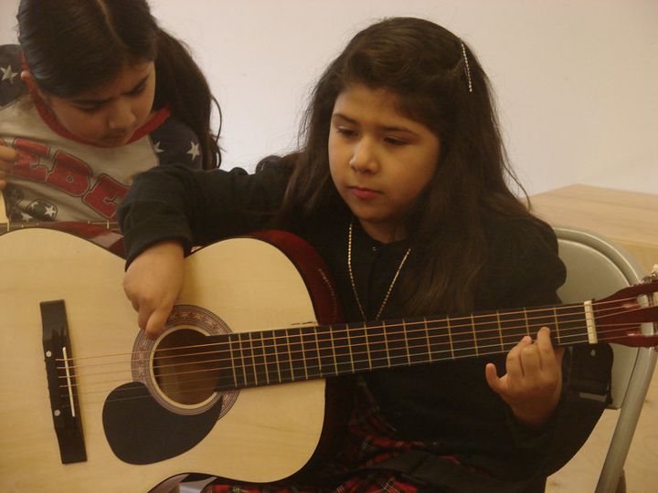 Isabella Barco, 7, practices a D chord in guitar class at Christ’s Foundry United Methodist Church in Dallas. 