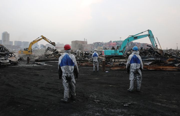 Workers clean the scene of the explosion in Tianjin, China, on Aug. 26, 2015.