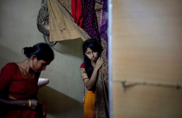 Nasoin Akhter looks out of a dressing room at a beauty parlour on the day of her wedding.