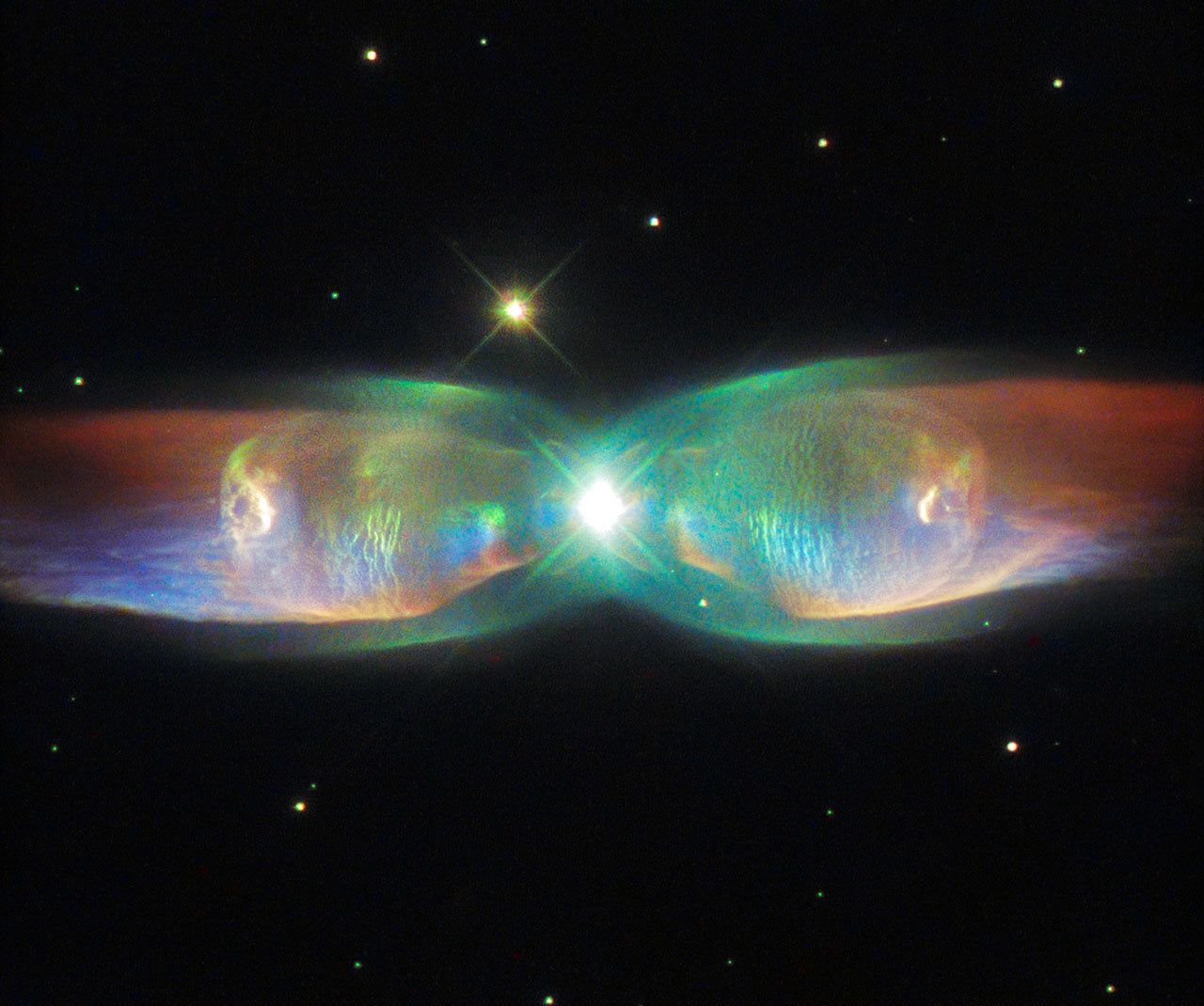 The shimmering colors visible in this Hubble Space Telescope image show off the remarkable complexity of the Twin Jet Nebula, or PN M2-9.