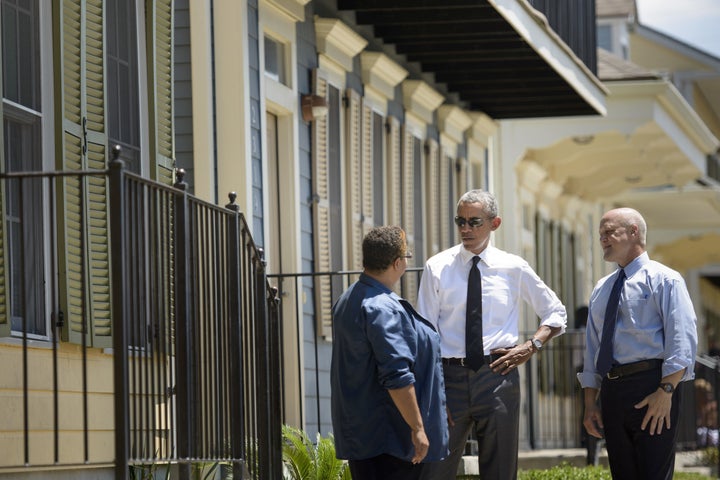 President Barack Obama (C) and New Orleans Mayor Mitch Landrieu (R) talk with a woman during a tour of the Treme neighborhood August 27, 2015 in New Orleans, Louisiana. President Obama visited New Orleans Thursday to praise its people's 'extraordinary resilience,' 10 years after Hurricane Katrina ravaged the 'Big Easy' and shattered Americans' confidence in government.