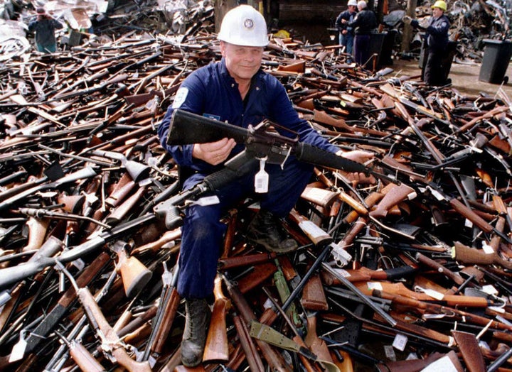 A project supervisor with a local security firm holds up an armalite rifle similar to the one used in the Port Arthur massacre and which was handed in for scrap in Melbourne after Australia banned all automatic and semi-automatic rifles in the aftermath of the Port Arthur shooting.