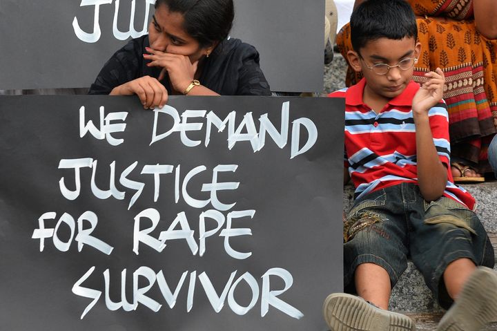 <p>Activists from various women's rights organization and children stage a silent demonstration against sexual assault and rapes on women, in Bangalore on April 22, 2015.</p>