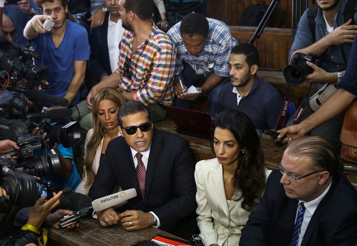 Canadian-Egyptian Al-Jazeera journalist Mohamed Fahmy (right 3), one of the three reporters sentenced to three year in jail by Egyptian court, his fiancee Marwa Omara (right 4) and lawyer Amal Clooney (right 2) are seen as Fahmy speaks to the media after a court session, in the Tora prison in Cairo, Egypt on August 29, 2015.