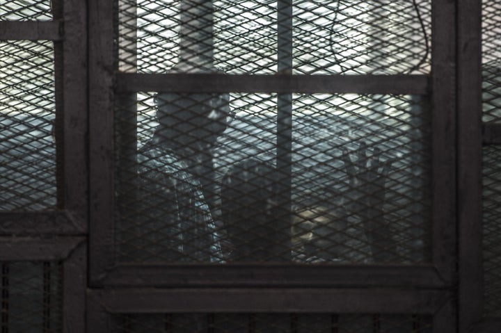 Al-Jazeera journalists, Canadian Mohamed Fahmy (R) and Egyptian Baher Mohamed (C), both accused of supporting the blacklisted
