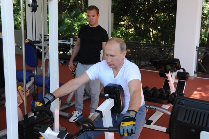 Russias President Vladimir Putin (C) and Russian Prime Minister Dmitry Medvedev work out at a gym at the Bocharov Ruchei state residence in Sochi on August 30, 2015.