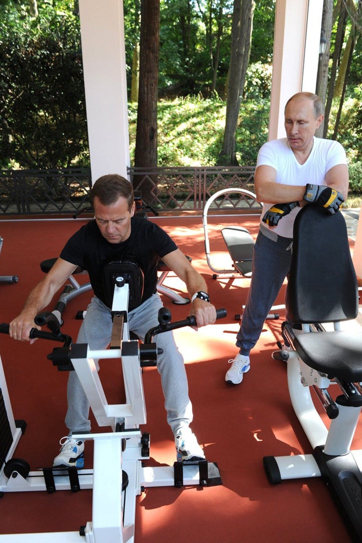 Russias President Vladimir Putin and Russian Prime Minister Dmitry Medvedev work out at a gym at the Bocharov Ruchei state residence in Sochi on August 30, 2015.