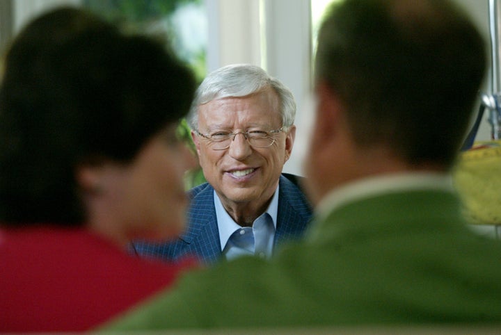 <p>EHarmony founder Neil Clark Warren talks with a couple who met on the website, on April 16, 2015.</p>