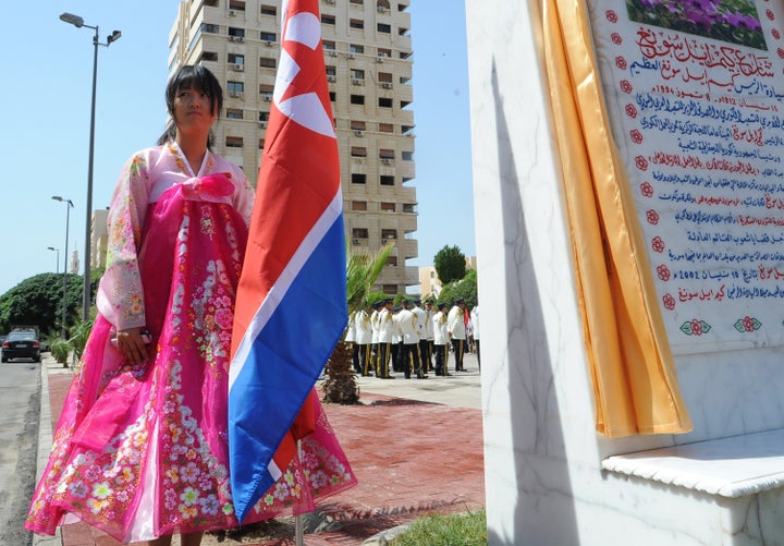 A young woman holds a North Korean flag during the inauguration ceremony of a park in the Syrian capital Damascus to honor North Korea's founding father Kim Il Sung on Aug. 31, 2015. 