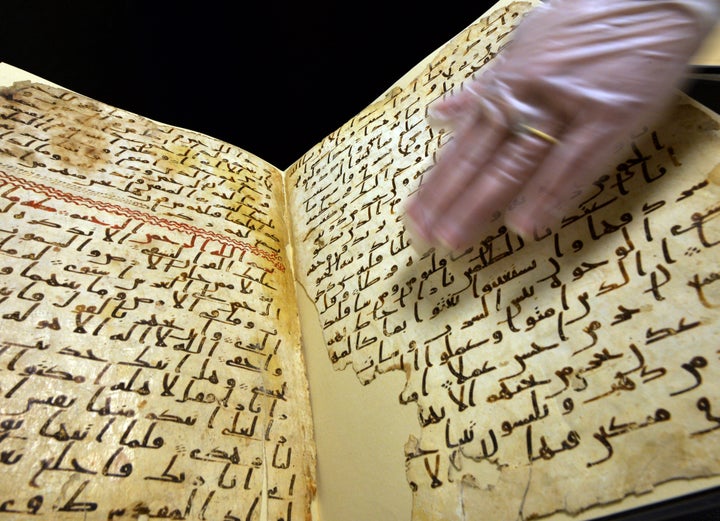 Marie Sviergula, conservator of the University of Birmingham holds a Quran manuscript in Birmingham England on July 22, 2015.