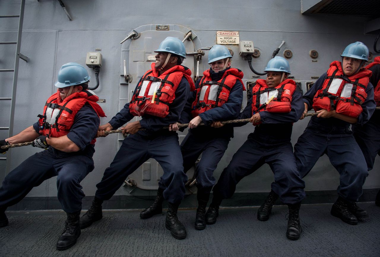 Sailors aboard the guided missile destroyer USS Chung-Hoon heave line during an underway replenishment. 