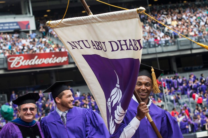 Graduates of NYU's Abu Dhabi campus march at the university's 2014 commencement ceremony at Yankee Stadium in New York. 